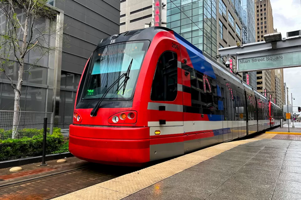 Red light rail train at outdoor platform in downtown Houston, Texas